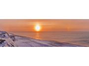 Sunset through windblown snow creates a sundog above the Beaufort Sea along the coast just outside of Barrow, Winter, Ar